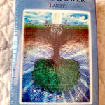 Box of Dreampower Tarot cards on quilt background