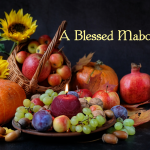 Blessed Mabon with candle pumpkins grapes pomagranates fruit flowers