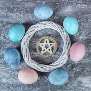 colored eggs around a wreath and pentagram ostara