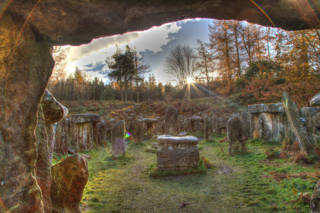 Stones At Druid Temple On Field Against Sky