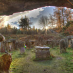 Stones At Druid Temple On Field Against Sky