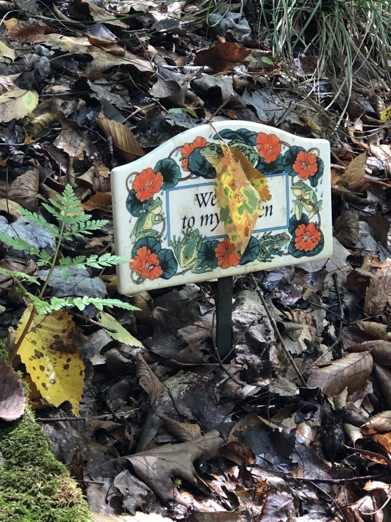 Autumn Leaf dangles on garden marker surrounded by other leaves