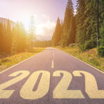 Empty asphalt road and New year 2022 concept. Driving on an empty road in the mountains to upcoming 2022.