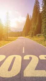 Empty asphalt road and New year 2022 concept. Driving on an empty road in the mountains to upcoming 2022.