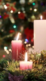 All five advent candles lit with tree and wreath sparkling