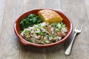 Traditional Hoppin John with rice beans greens and cornbread for New Years