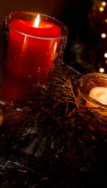 Three votive holiday candles twinkling with wreath