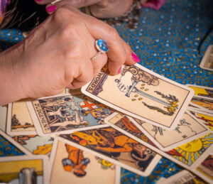 Psychic hand pulling R-W-S cards face up