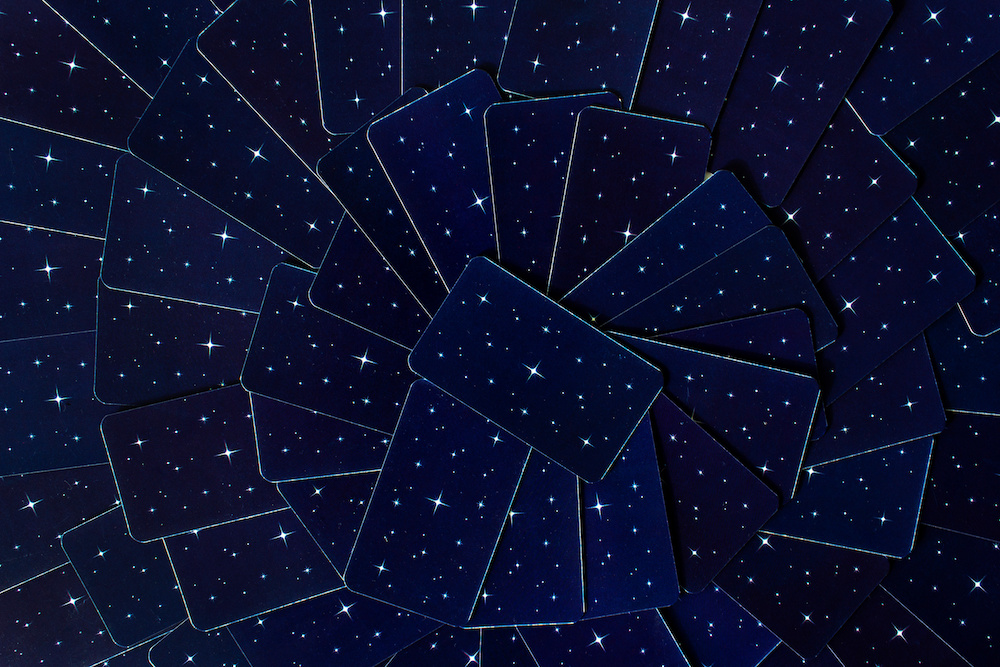 abstract background with tarot cards deck blue stars sky