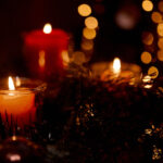 Yule holiday candles with twinkle lights and wreath