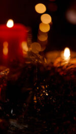 Yule holiday candles with twinkle lights and wreath
