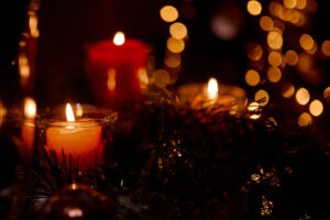 Yule holiday candles with twinkle lights and wreath