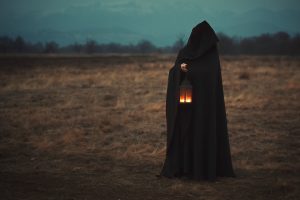 Dark Goddess with lantern in desolate land