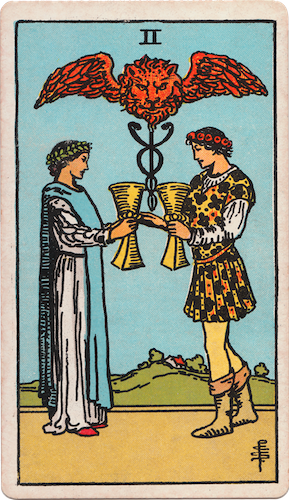 Waite-Smith Tarot two of cups young couple exchanging golden goblets and blessed by lion creature above