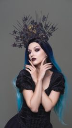 haute couture goth woman posing as a witch